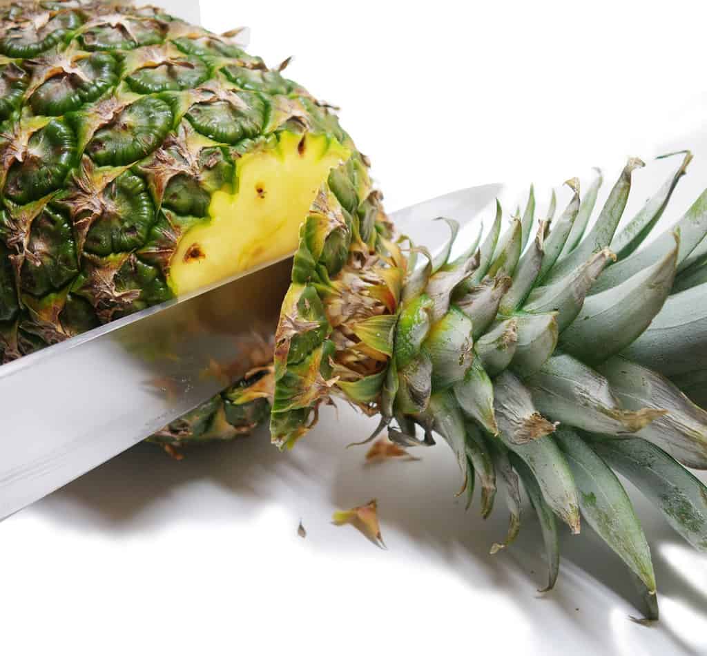 Slicing pineapple top